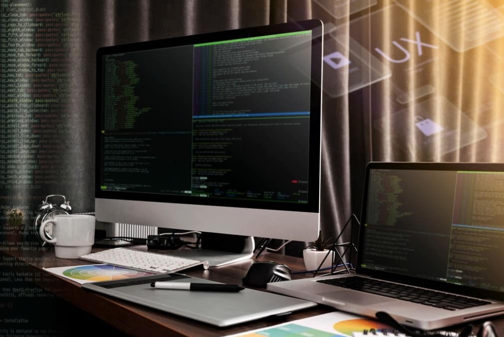 Over-the-shoulder view of a person coding on a laptop