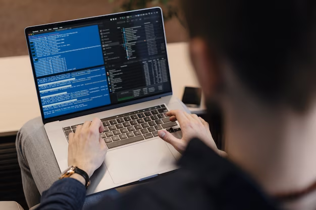 Person coding on a laptop